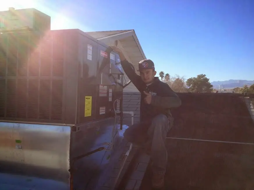 HVAC technician performing Boiler Repair on a rooftop unit in Carpinteria